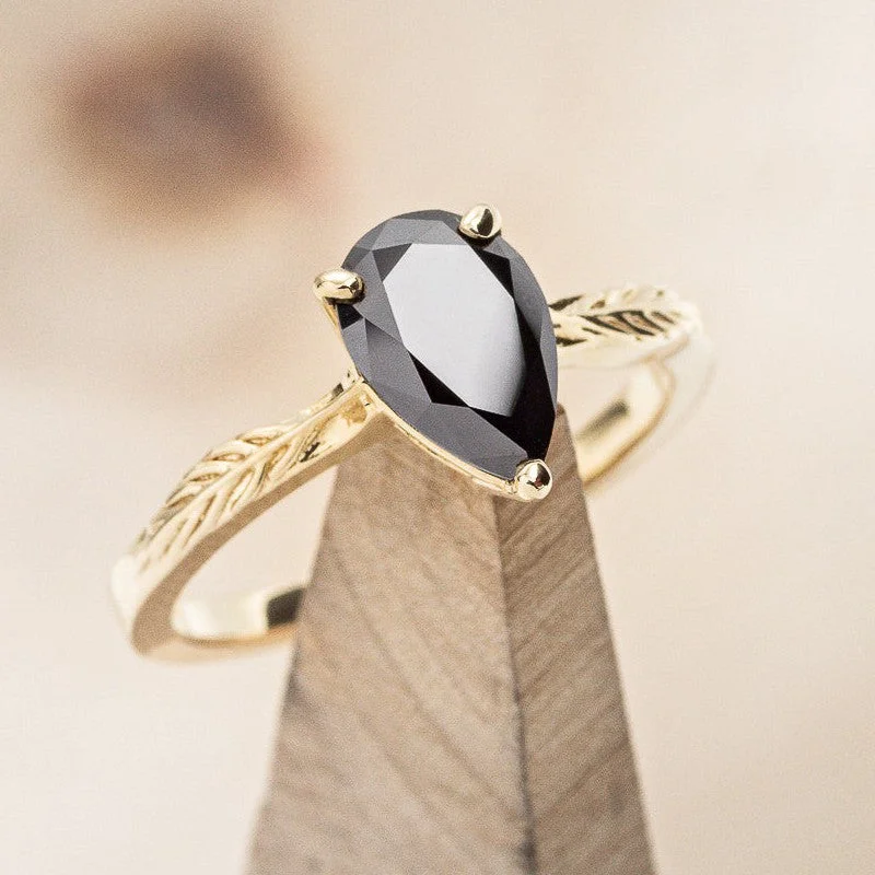 "HOPE" - PEAR CUT MIDNIGHT BLACK MOISSANITE SOLITAIRE ENGAGEMENT RING WITH FEATHER ACCENTS